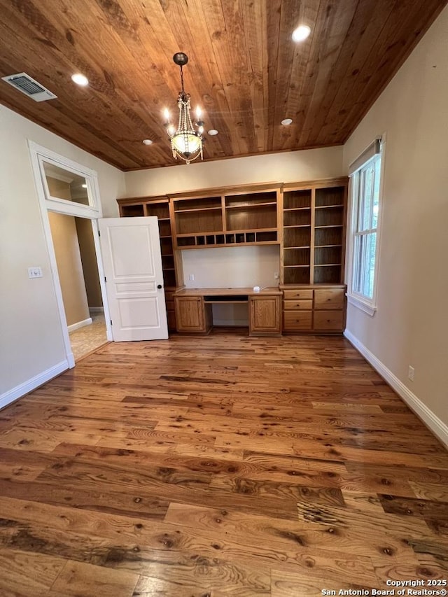 1844 Reeh Rd, Fredericksburg, TX 78624 - unfurnished living room with visible vents, built in desk, wood ceiling, dark wood finished floors, and recessed lighting