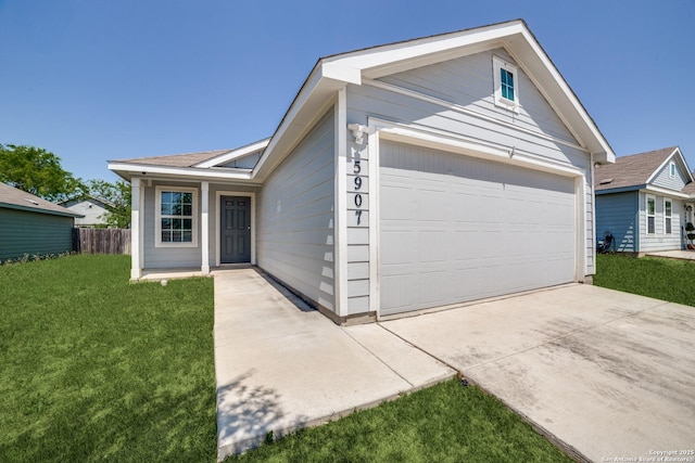 ranch-style home with a garage, a front yard, driveway, and fence
