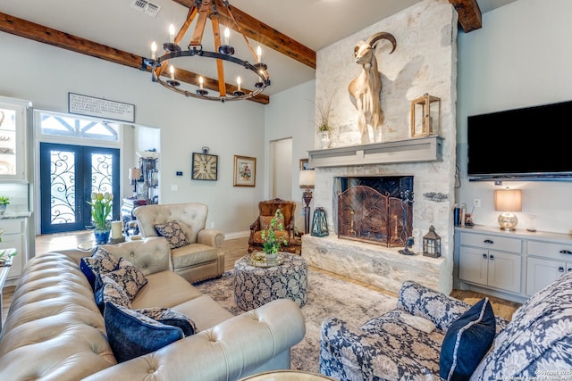 living area featuring light wood-type flooring, a chandelier, french doors, visible vents, and beamed ceiling