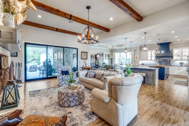 living room featuring beamed ceiling, light wood-type flooring, an inviting chandelier, and recessed lighting