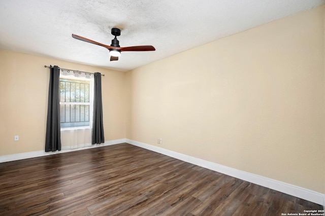 unfurnished room featuring a ceiling fan, a textured ceiling, baseboards, and dark wood finished floors