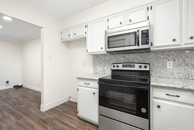 kitchen with tasteful backsplash, baseboards, white cabinetry, dark wood finished floors, and appliances with stainless steel finishes