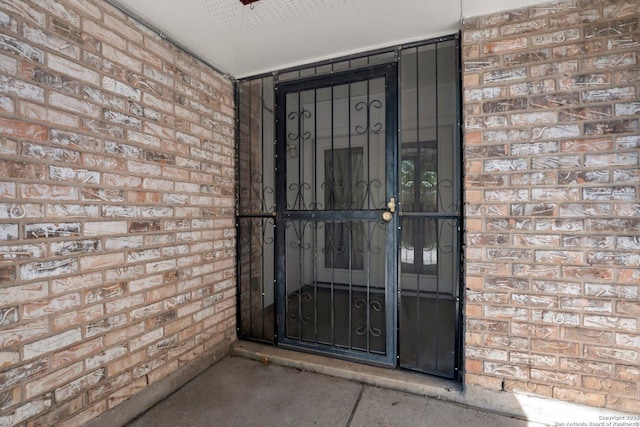property entrance with brick siding