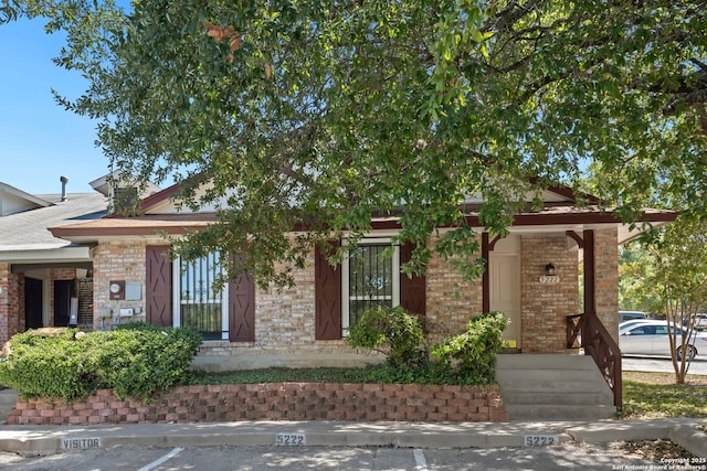 obstructed view of property featuring brick siding