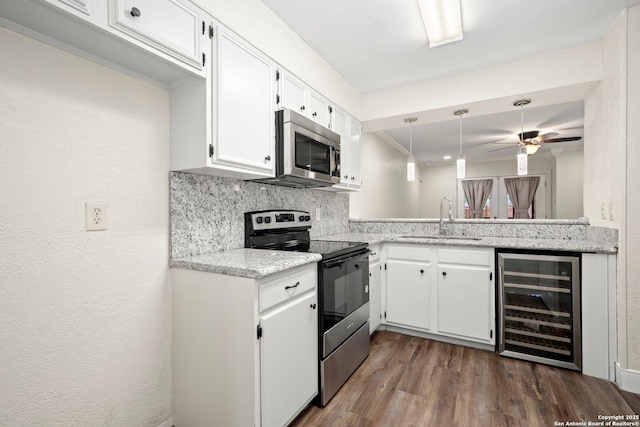 kitchen featuring a sink, dark wood-style flooring, appliances with stainless steel finishes, decorative backsplash, and beverage cooler