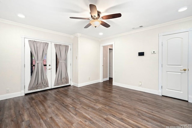 empty room with crown molding, baseboards, a ceiling fan, and wood finished floors
