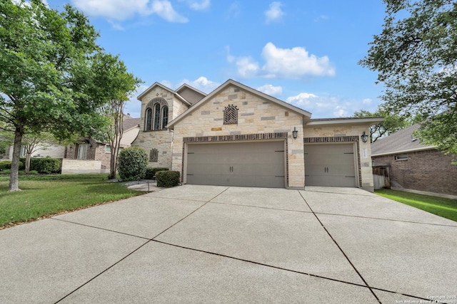 11347 Phoebe Lace, San Antonio, TX 78253 - view of front of property with a garage, driveway, stone siding, and a front lawn