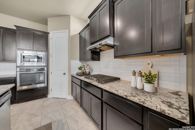 11347 Phoebe Lace, San Antonio, TX 78253 - kitchen with stainless steel appliances, under cabinet range hood, backsplash, and light stone counters