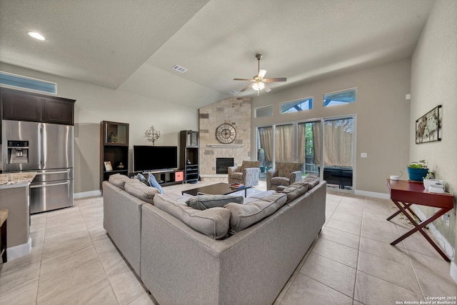 11347 Phoebe Lace, San Antonio, TX 78253 - living area featuring light tile patterned floors, baseboards, a ceiling fan, and a fireplace