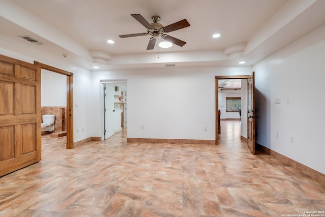 unfurnished room featuring a tray ceiling, recessed lighting, visible vents, and a ceiling fan