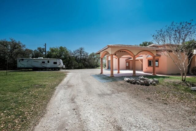 view of road with dirt driveway