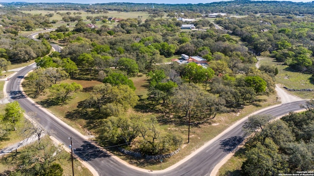 birds eye view of property featuring a wooded view