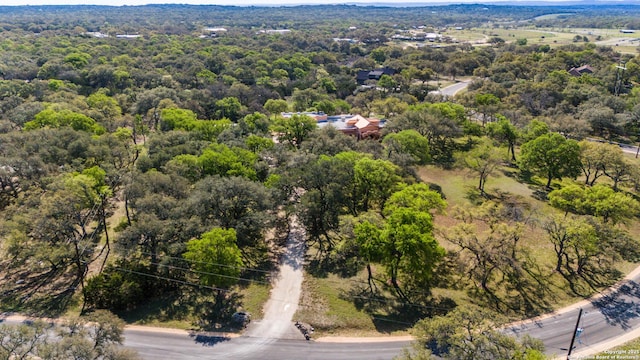 bird's eye view with a wooded view
