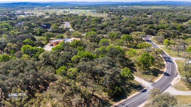 birds eye view of property featuring a wooded view