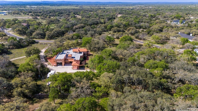 drone / aerial view featuring a view of trees