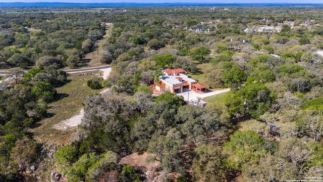 birds eye view of property featuring a wooded view