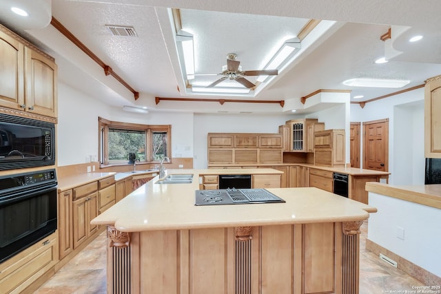 kitchen featuring a sink, light countertops, black appliances, and a center island with sink