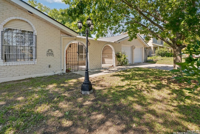 6826 Horwich, San Antonio, TX 78239 - ranch-style home with a front yard, a garage, brick siding, a gate, and driveway