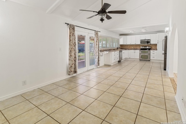 6826 Horwich, San Antonio, TX 78239 - kitchen with a sink, stainless steel appliances, decorative backsplash, vaulted ceiling with beams, and light tile patterned flooring