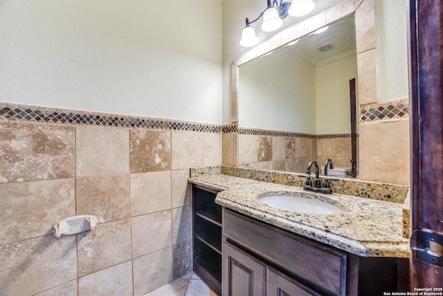 12022 Del Rio Run, San Antonio, TX 78245 - bathroom with tile walls, a wainscoted wall, crown molding, vanity, and tile patterned floors