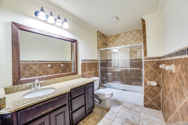 12022 Del Rio Run, San Antonio, TX 78245 - bathroom with crown molding, vanity, toilet, enclosed tub / shower combo, and tile walls