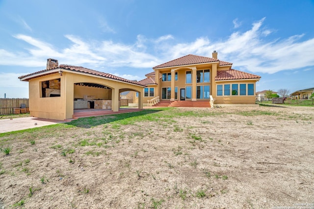12022 Del Rio Run, San Antonio, TX 78245 - back of house with a tiled roof, fence, stucco siding, and a chimney