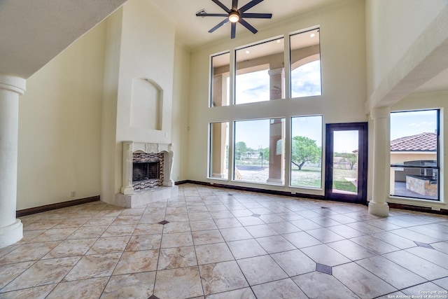 12022 Del Rio Run, San Antonio, TX 78245 - unfurnished living room featuring ceiling fan, decorative columns, a fireplace, and baseboards