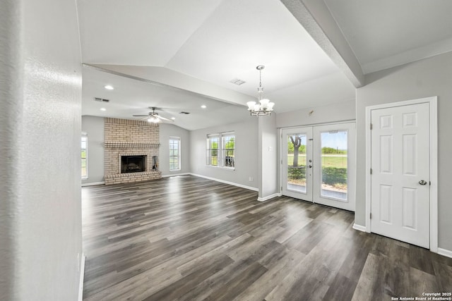 unfurnished living room with dark wood finished floors, visible vents, baseboards, and lofted ceiling