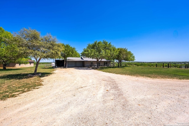 view of front of home featuring a front yard, driveway, and a garage