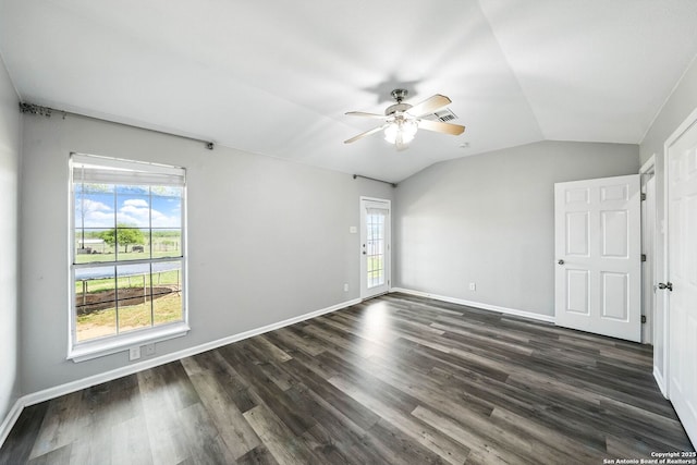 unfurnished room with dark wood-type flooring, ceiling fan, vaulted ceiling, and baseboards