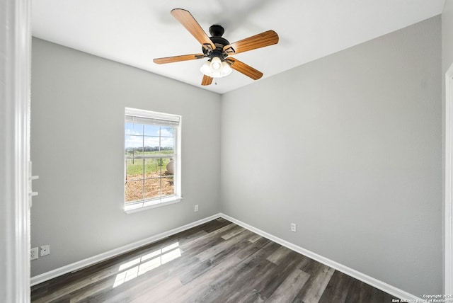 spare room featuring ceiling fan, baseboards, and dark wood finished floors