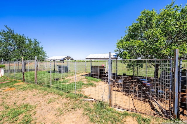 view of yard featuring an outbuilding and fence