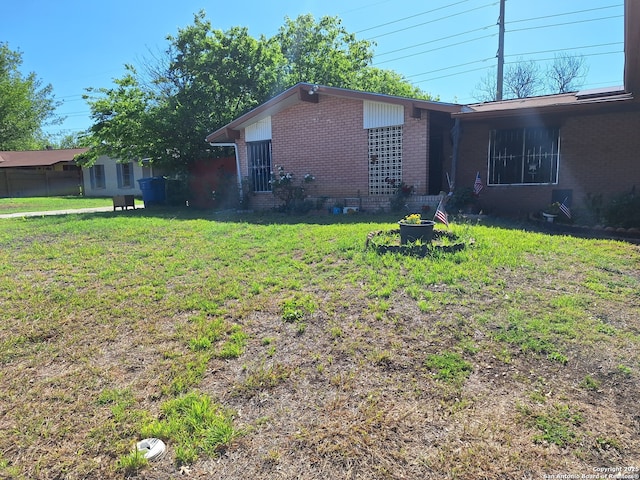 exterior space featuring a front yard and brick siding