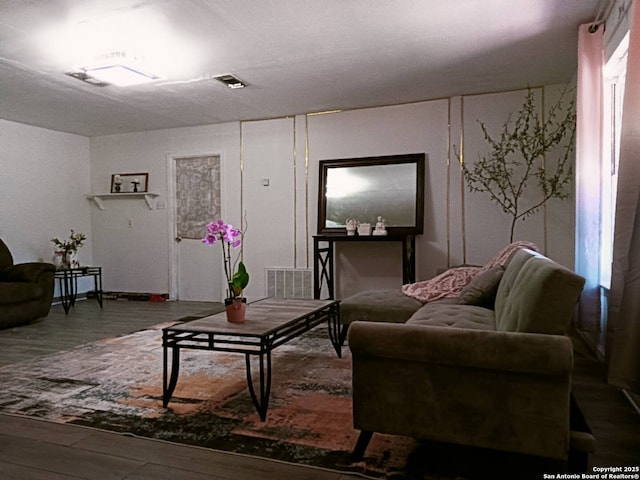living room with visible vents and wood finished floors