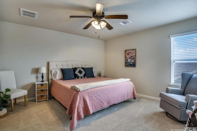 carpeted bedroom featuring visible vents, baseboards, and ceiling fan