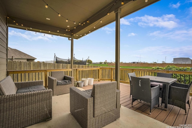 wooden terrace featuring outdoor dining area and fence