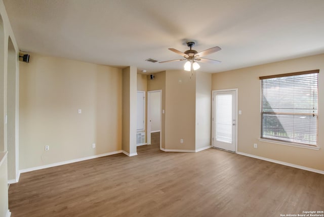 unfurnished room with visible vents, baseboards, light wood-type flooring, and a ceiling fan