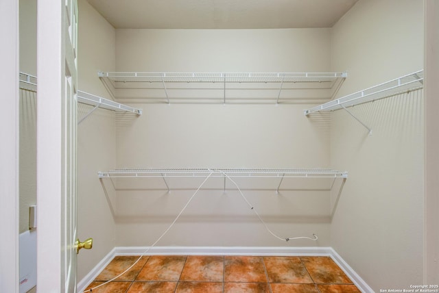 spacious closet with tile patterned floors