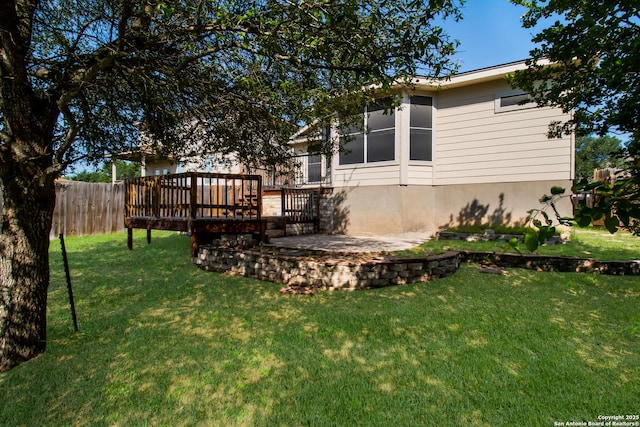 view of yard featuring fence and a wooden deck