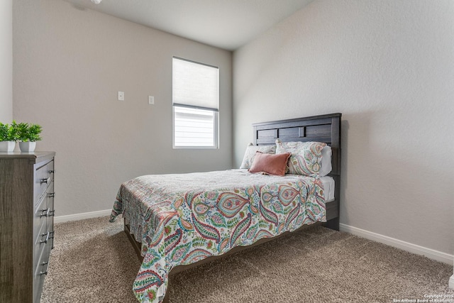 bedroom featuring baseboards and carpet floors