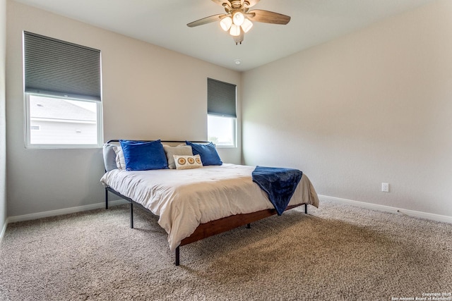carpeted bedroom with baseboards and a ceiling fan