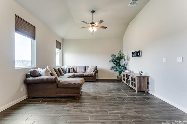 living area with visible vents, baseboards, a ceiling fan, wood finish floors, and vaulted ceiling