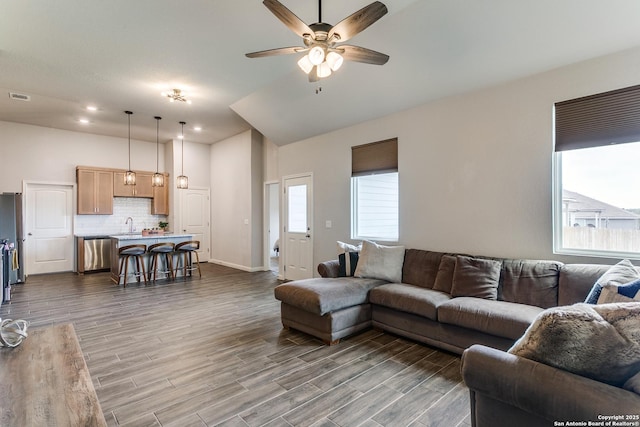 living area featuring ceiling fan, baseboards, dark wood-style floors, and visible vents