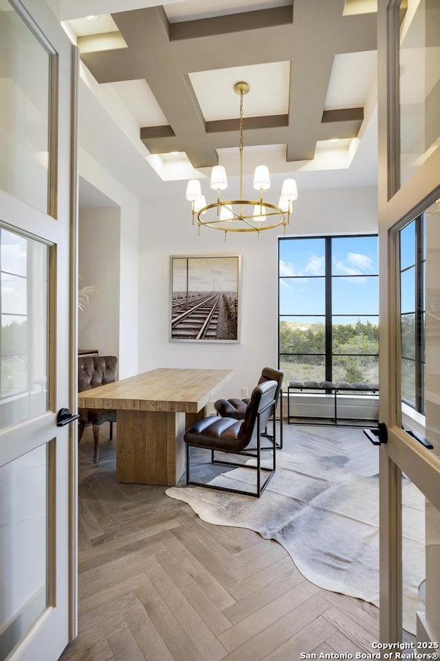 dining area featuring coffered ceiling, beam ceiling, a high ceiling, and an inviting chandelier