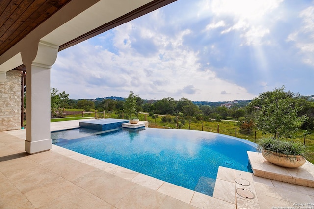 view of swimming pool featuring a patio area, a jacuzzi, fence, and a fenced in pool