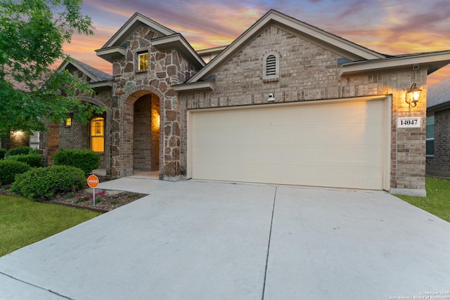 14047 Pikesdale, San Antonio, TX 78253 - view of front facade featuring driveway, a garage, and stone siding