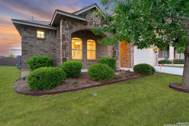 14047 Pikesdale, San Antonio, TX 78253 - view of front of home with an attached garage, stone siding, a lawn, brick siding, and driveway