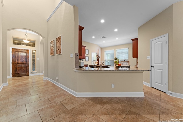 14047 Pikesdale, San Antonio, TX 78253 - kitchen featuring light stone countertops, arched walkways, visible vents, recessed lighting, and baseboards