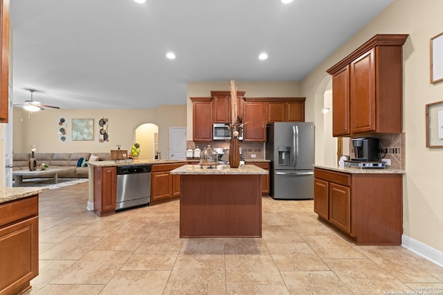 14047 Pikesdale, San Antonio, TX 78253 - kitchen featuring arched walkways, a ceiling fan, backsplash, and appliances with stainless steel finishes