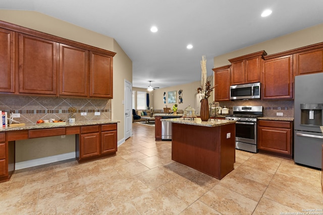 14047 Pikesdale, San Antonio, TX 78253 - kitchen with open floor plan, appliances with stainless steel finishes, built in study area, a kitchen island, and lofted ceiling
